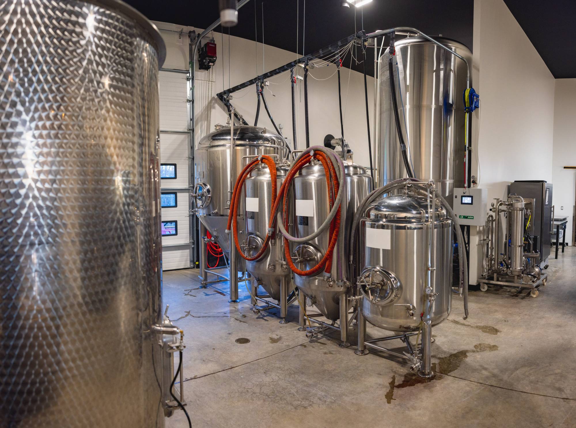 Stainless steel fermentation tanks inside Zip Kombucha brewery in Anchorage Alaska
