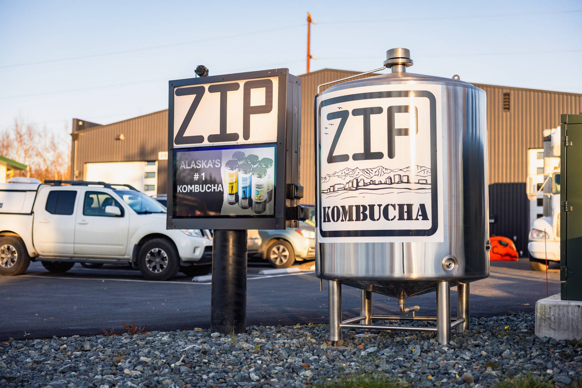 Zip Kombucha branded fermentation tank and sign outside the brewery in Anchorage Alaska