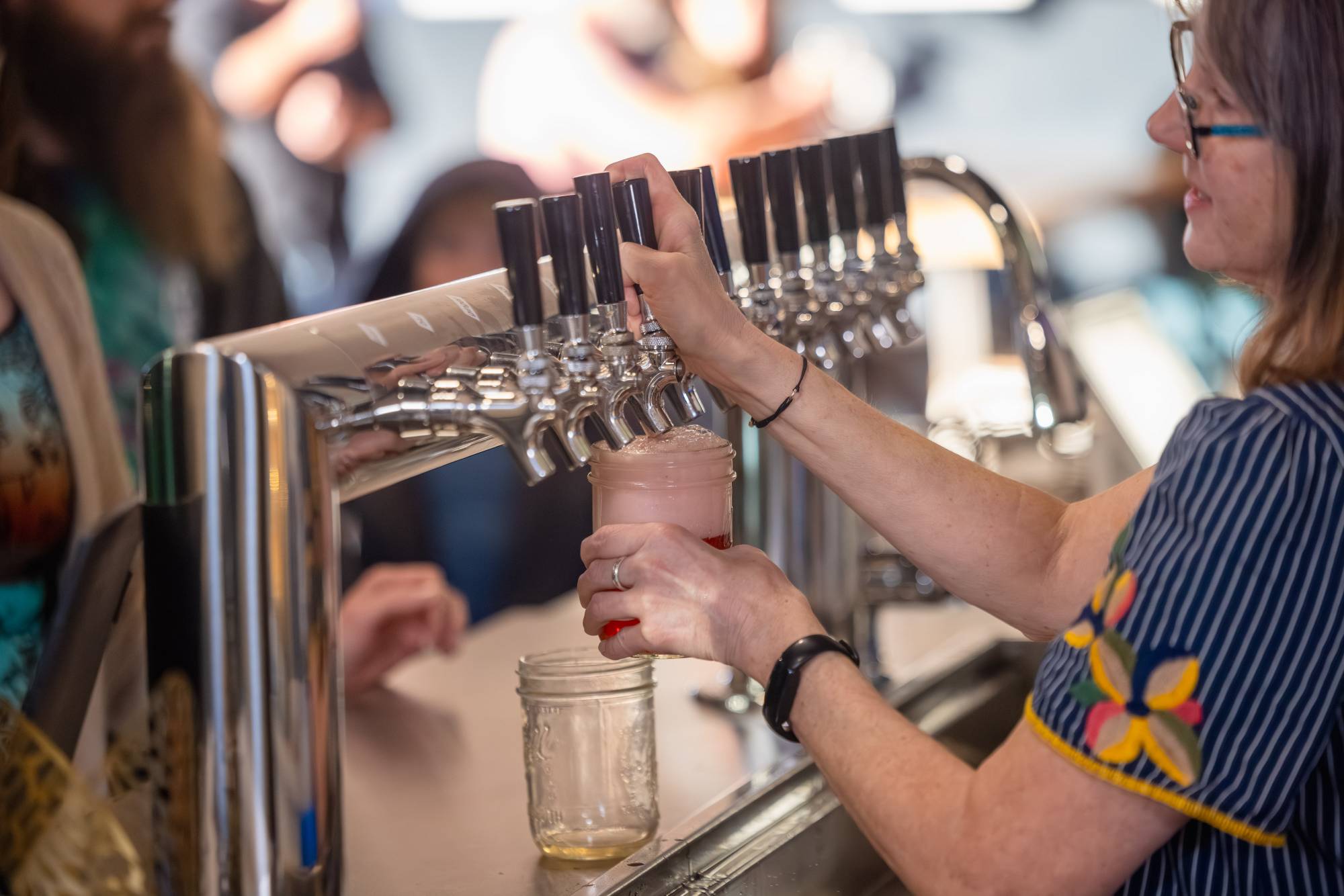 Pouring kombucha from tap at Zip Kombucha taproom in Anchorage Alaska