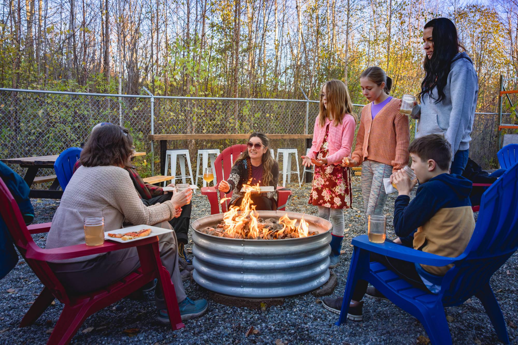 Families enjoying kombucha around the fire pit at Zip Kombucha taproom